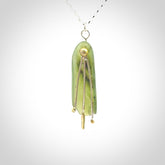 This kowhai flower drop pendant is beautifully hand made with gorgeous flair. It is fashionable and perfect for a women with style. Hand carved from a gorgeous piece of New Zealand jade with Gold leaf coating and sterling silver - this is an elegant and beautiful piece of art to wear.